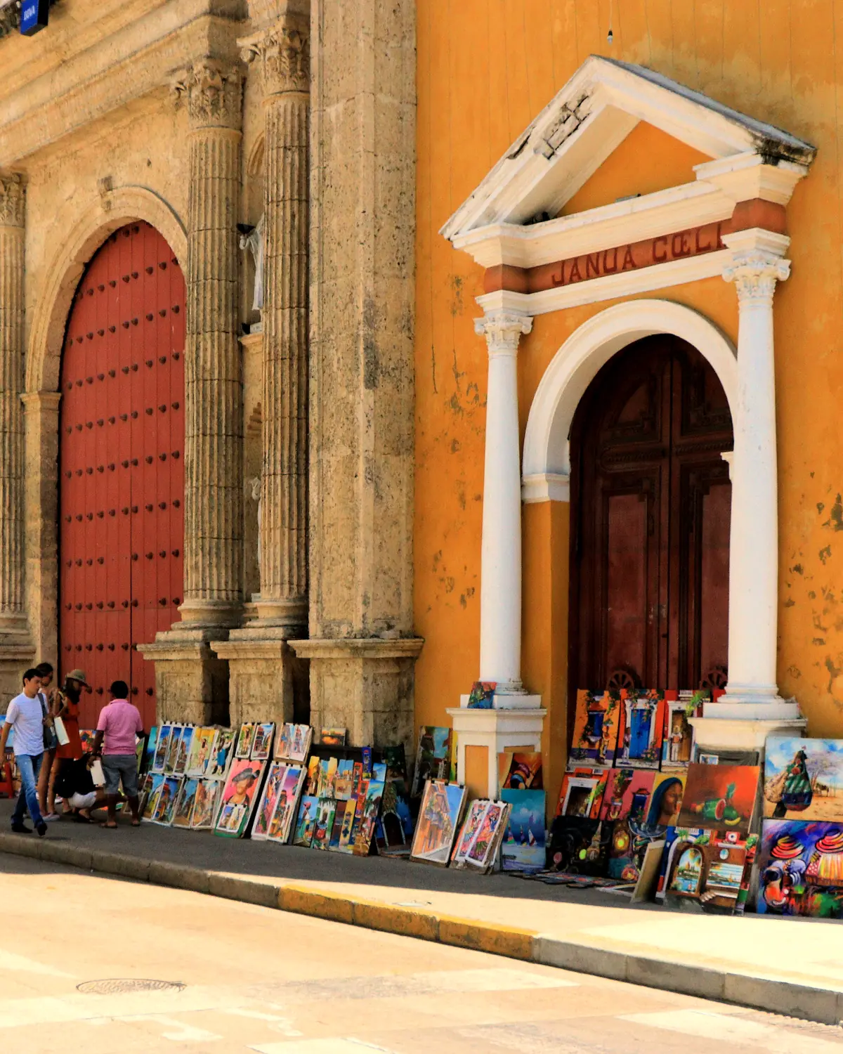 Artists paintings on sale in front of Cathedral, Cartagena, Colombia Old Town. The full formal name of the cathedral is the Metropolitan Cathedral Basilica of Saint Catherine of Al
