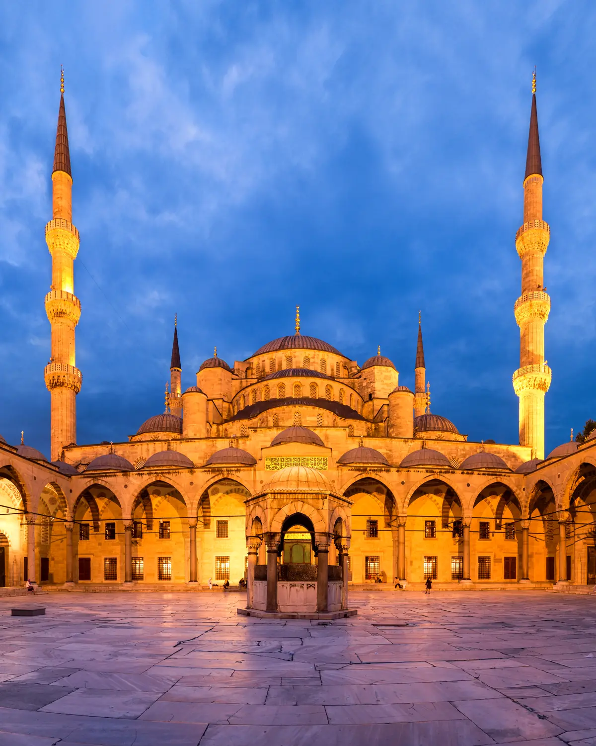 Panoramic view of the courtyard of the Blue Mosque, in Istanbul, Turkey. The courtyard has a square shape, but the mercator projection necessary to squeeze all the field of view in