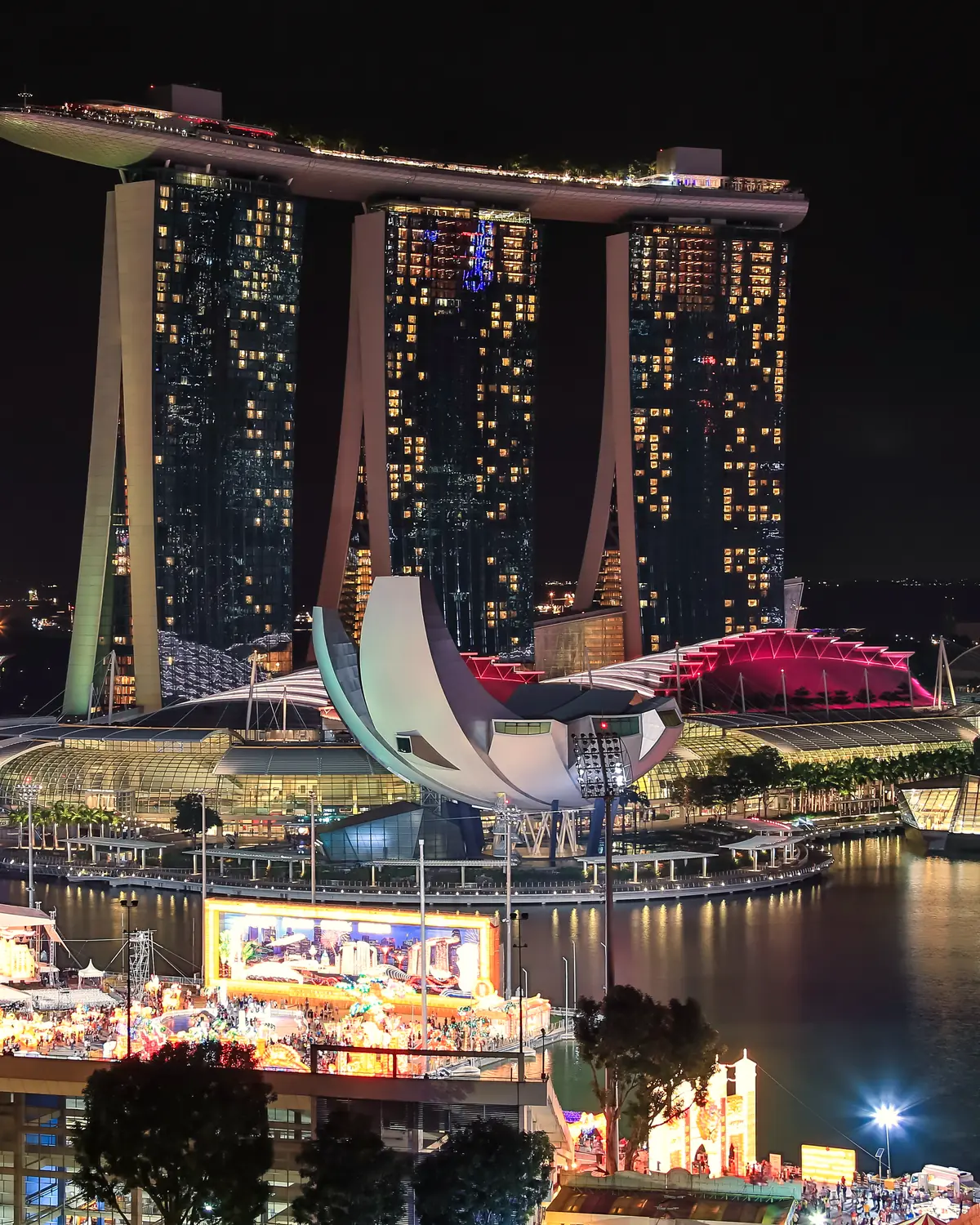 Marina Bay, Singapore at night: the bay, the skyline and the hotel towers lit before a firework display
