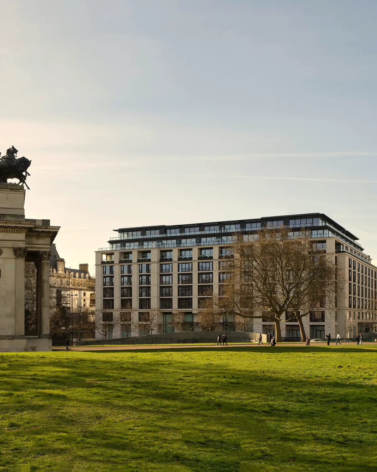 Hotel exterior seen across the Hyde Park Corner lawn, with Wellington Arch on the left (caption: 'Hotel Exterior')