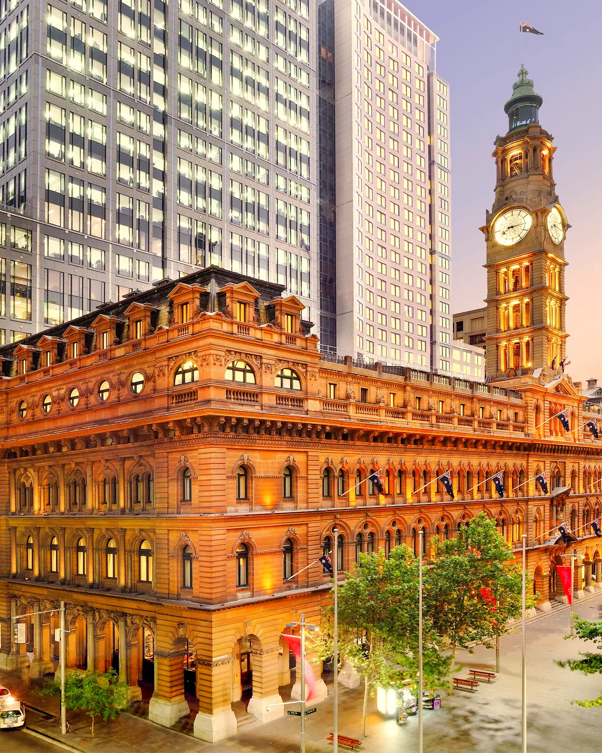 The former General Post Office building at No. 1 Martin Place, which houses the hotel, with its clock tower, at dusk (caption: "The Fullerton Hotel Sydney...